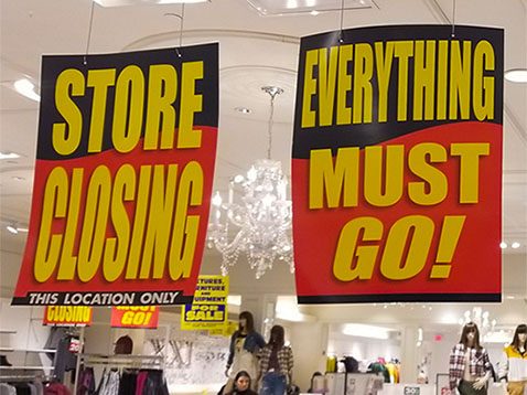 Custom Ceiling Danglers hanging from a ceiling in a store